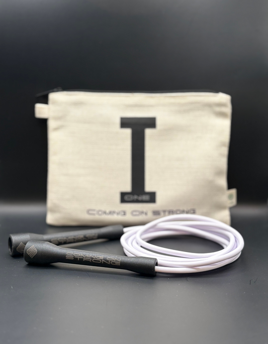White Coming On Strong jump rope with tan hemp carry bag and black handles.