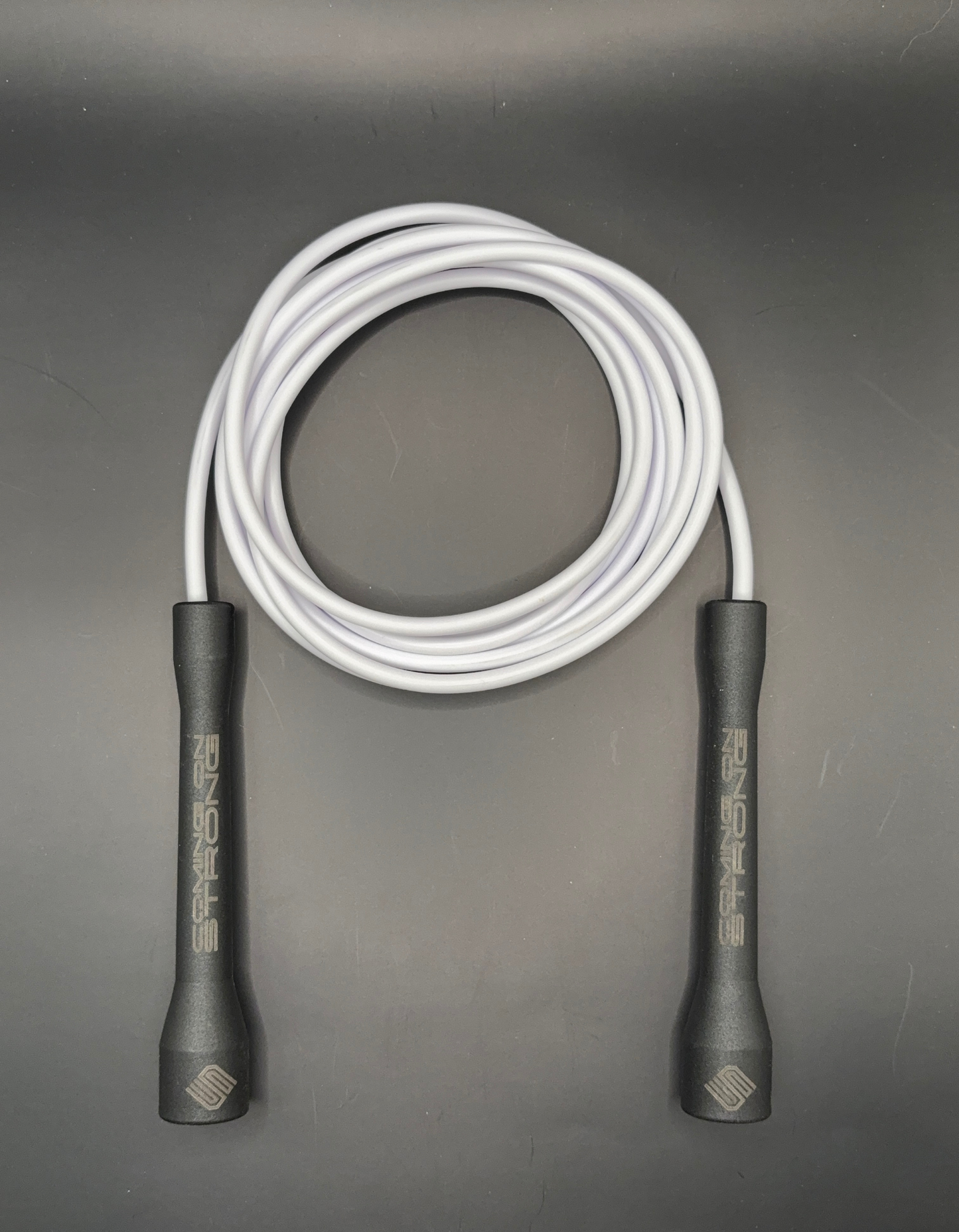White Coming On Strong 5mm  jump rope with  black handles.