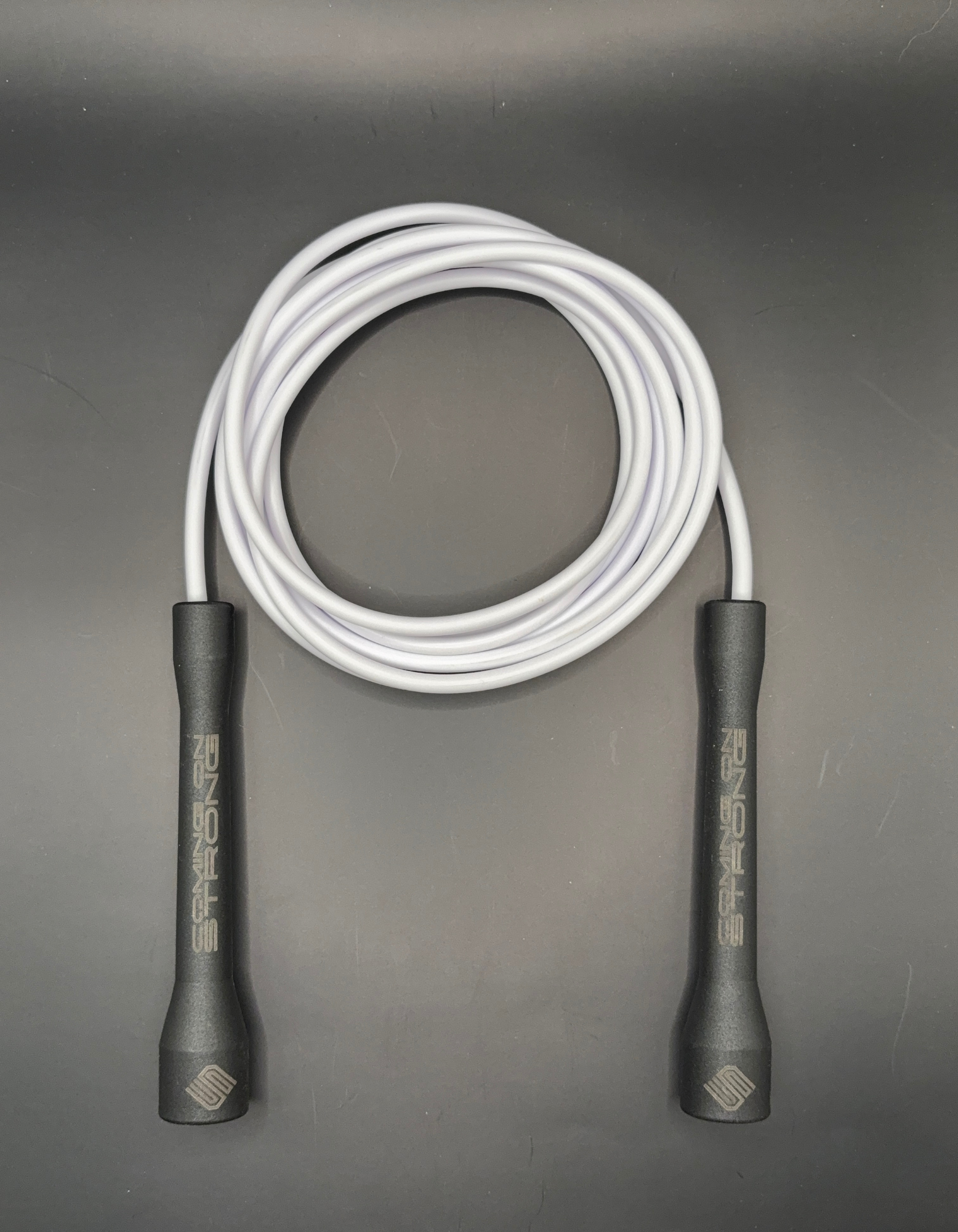 White Coming On Strong 5mm  jump rope with  black handles.