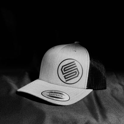 Stylish snapback hat on black background from Coming On Strong. 