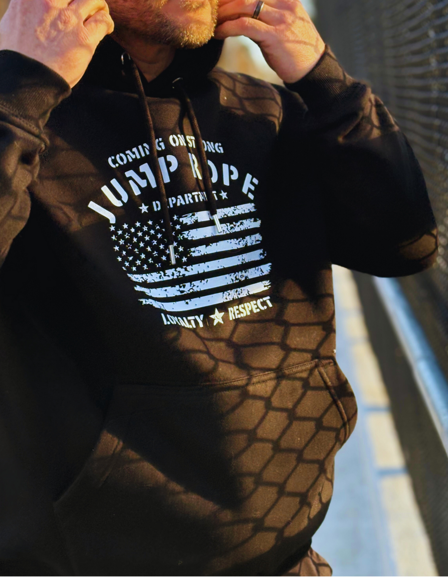 Dan Bantell wearing a black Coming On Strong loyalty respect hoodie outside. 